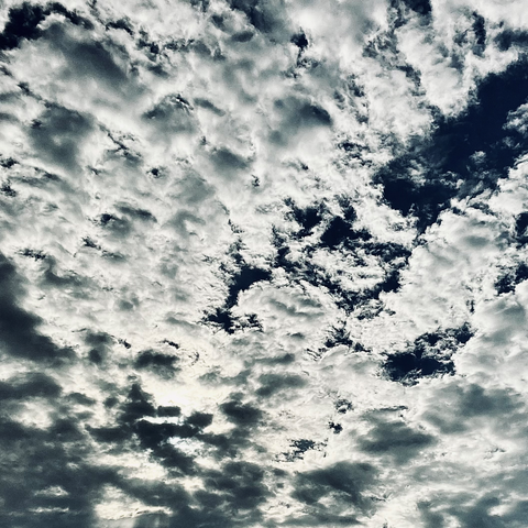 Color image of clouds gathering in the morning sky over Akron, Summit County, Ohio, on another hot June day approaching 90 degrees Fahrenheit. Image shows bands of windmilling clouds building over the eastern sky as the sun rises.