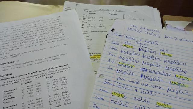 A collection of photocopied and written notes which deal with ancient Greek grammar. Some words are highlighted in yellow.