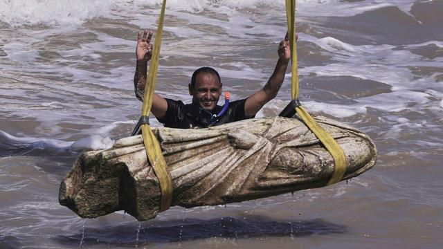 A diver celebrates after one of the ancient relics was lifted out of the water in the Abu Qir Bay in the Mediterranean Sea city of Alexandria, Egypt, Thursday, Aug. 21, 2025. (AP Photo/Amr Nabil)