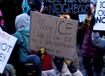 protester holding a sign that reads "the only ice I like is the ice my 2 gay boyfriends skate around on"